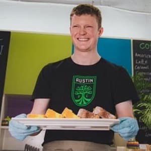 Man carrying a tray of cakes