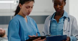 Two doctors looking at patient notes
